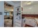 Bright kitchen with white cabinets, open shelving, and convenient access to living room at 6260 W 45Th Pl, Wheat Ridge, CO 80033