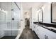 Bright bathroom with double vanity sinks, walk-in closet, and glass walk-in shower at 875 Coal Bank Trl, Castle Rock, CO 80104