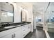 Bathroom featuring double vanity sink, glass-enclosed shower, and access to bedroom at 875 Coal Bank Trl, Castle Rock, CO 80104