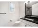 Modern bathroom with sleek black fixtures, a toilet, and a vanity with a black countertop at 875 Coal Bank Trl, Castle Rock, CO 80104
