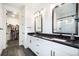 Bathroom with a walk-in closet, double vanity sinks, and glass-enclosed shower at 875 Coal Bank Trl, Castle Rock, CO 80104