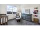 Charming Bedroom with a crib, glider, changing table, and bright natural light from the large window at 875 Coal Bank Trl, Castle Rock, CO 80104