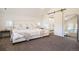 Primary bedroom with walk-in shower, barn door, plush bed and carpeted floor at 875 Coal Bank Trl, Castle Rock, CO 80104