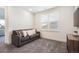 Bonus room featuring a comfortable gray sofa and soft carpeting at 875 Coal Bank Trl, Castle Rock, CO 80104