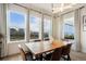 Bright dining room with large windows showcasing beautiful mountain views and modern light fixture at 875 Coal Bank Trl, Castle Rock, CO 80104