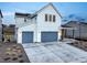 Modern home exterior with two-car garage and covered front porch at 875 Coal Bank Trl, Castle Rock, CO 80104