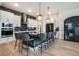 Modern kitchen features large island with seating, pendant lighting, and stainless steel appliances at 875 Coal Bank Trl, Castle Rock, CO 80104