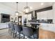 Modern kitchen showcasing large island, pendant lights, white cabinets, and stainless steel appliances at 875 Coal Bank Trl, Castle Rock, CO 80104