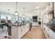 Modern kitchen featuring a central island, stainless steel appliances, hardwood floors, and an open layout at 875 Coal Bank Trl, Castle Rock, CO 80104