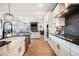 Gourmet kitchen featuring sleek cabinetry, modern appliances, ample counter space, and easy access to the living area at 875 Coal Bank Trl, Castle Rock, CO 80104