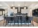 Modern kitchen with a large island, stylish lighting, stainless steel appliances, and sleek countertops at 875 Coal Bank Trl, Castle Rock, CO 80104