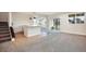 Open-concept living room with a bar, sleek stairs, and walk-out patio access at 875 Coal Bank Trl, Castle Rock, CO 80104