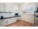 Bright office space with built-in cabinets, desk, and hardwood floors at 875 Coal Bank Trl, Castle Rock, CO 80104