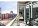 Relax on this balcony with a black chair, clear view, and access to an indoor living space at 4200 W 17Th Ave # 419, Denver, CO 80204
