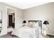 A calm, neutral bedroom with patterned pillows, side tables, and view into a walk in closet at 4200 W 17Th Ave # 419, Denver, CO 80204