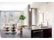Bright kitchen and living area featuring modern pendant lighting, granite countertops, and stainless steel appliances at 4200 W 17Th Ave # 419, Denver, CO 80204