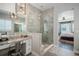 Bathroom boasts glass shower with vanity and makeup area, with natural light and tile flooring at 9380 Bear River St, Littleton, CO 80125