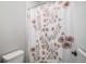Bright bathroom showcasing a floral shower curtain adding a touch of elegance at 9380 Bear River St, Littleton, CO 80125