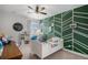 Bright bedroom featuring designer accent wall, ceiling fan, and plentiful natural light at 9380 Bear River St, Littleton, CO 80125