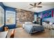 Bedroom with unique wood accent wall, ceiling fan and plenty of natural light at 9380 Bear River St, Littleton, CO 80125