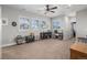Spacious bonus room featuring ceiling fan, lots of light, and plush carpeted floors at 9380 Bear River St, Littleton, CO 80125