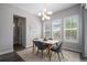Modern dining room featuring a stylish chandelier, large windows, and a neutral color palette at 9380 Bear River St, Littleton, CO 80125