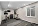 Well-lit exercise room featuring a treadmill, stationary bike, and sleek black storage cabinet at 9380 Bear River St, Littleton, CO 80125