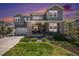 Inviting two-story home with a stone facade, manicured lawn, and a welcoming front porch at 9380 Bear River St, Littleton, CO 80125