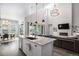 Open-concept kitchen featuring a large island, modern lighting, and seamless flow to the living area at 9380 Bear River St, Littleton, CO 80125