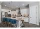 Bright kitchen with white cabinets, stainless steel appliances, granite countertops, and stylish pendant lights at 9380 Bear River St, Littleton, CO 80125