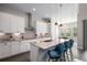 Bright, modern kitchen with a large island, pendant lighting, and ample cabinet space at 9380 Bear River St, Littleton, CO 80125