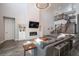 Bright living room featuring a modern fireplace, built-in shelving, and open floor plan at 9380 Bear River St, Littleton, CO 80125