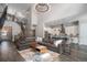 Spacious living room featuring a modern chandelier, open to the kitchen, and a staircase leading to the second floor at 9380 Bear River St, Littleton, CO 80125