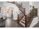 Elegant staircase with wood railings and carpeted steps, leading to the upper level of the home at 9380 Bear River St, Littleton, CO 80125