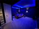 Basement theater room with blue accent lighting and comfortable seating at 9380 Bear River St, Littleton, CO 80125
