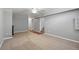 A partially finished basement with neutral walls and carpet adjacent to the stairs with wood flooring and a ceiling fan at 2582 S Uno Way, Denver, CO 80219
