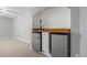Basement mini-bar features stainless steel mini-fridges, wood countertop, lighting, and a bar tap at 2582 S Uno Way, Denver, CO 80219