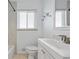 Bright bathroom with white vanity, tile surround, and shower/tub combo at 2582 S Uno Way, Denver, CO 80219