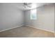 Bedroom includes neutral walls, carpet, a ceiling fan, and a window for natural light at 2582 S Uno Way, Denver, CO 80219