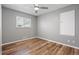 Bedroom featuring a ceiling fan, gray walls, and wood-look floors at 2582 S Uno Way, Denver, CO 80219