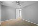 Bedroom features neutral walls, carpet, ceiling fan, and a closet with an open door at 2582 S Uno Way, Denver, CO 80219