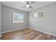 Bedroom with neutral walls, ceiling fan, and wood-look floors at 2582 S Uno Way, Denver, CO 80219