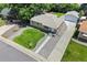 Charming single-story home featuring a well-manicured lawn, detached garage, and a welcoming walkway at 2582 S Uno Way, Denver, CO 80219