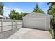 Exterior view of a well-maintained garage with fresh paint and a new driveway at 2582 S Uno Way, Denver, CO 80219