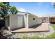 Detached garage with side access, accompanied by a small deck and well-kept lawn at 2582 S Uno Way, Denver, CO 80219