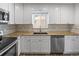 Bright kitchen with white cabinets, stainless steel appliances, and granite countertops at 2582 S Uno Way, Denver, CO 80219