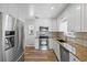 Modern kitchen features stainless steel appliances, granite countertops, and white cabinets at 2582 S Uno Way, Denver, CO 80219