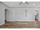 Spacious living room with stylish wood flooring, recessed lighting, and built-in shelving at 2582 S Uno Way, Denver, CO 80219