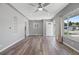 Bright living room featuring modern ceiling fan, neutral walls, and wood-look floors at 2582 S Uno Way, Denver, CO 80219