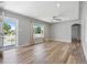 Open living room featuring wood flooring, recessed lighting, and a large window for natural light at 2582 S Uno Way, Denver, CO 80219